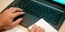 Hands using a computer keyboard while searching the internet with clear guide notes